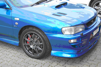 The Subaru Impreza showing the repaired and refinished wheel